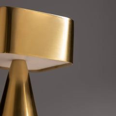 Close-up of a gold metallic object on a dark gray background