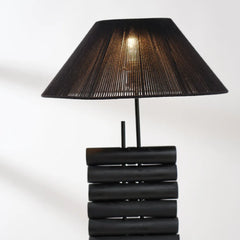 Black table lamp with a textured shade on a white background
