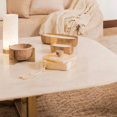 Athena Rectangular Box with white pearls placed on a marble coffee table with a beige sofa in the background.