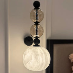 Modern wall-mounted light, detail shot of veined alabaster texture catching light through the stone panel

