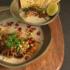 Plated Comet Bowls with garnishes on a wooden tray
