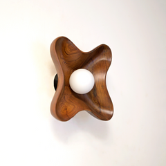 Side view of Compass Wall Light showing brass-finished metal and curved design