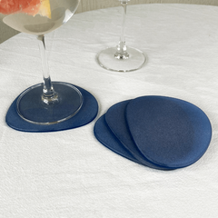 Decorative Blue Frosted Glass Coasters Set of 4, placed on a table with two glasses of water.