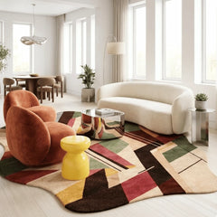 Modern living room with a colorful geometric rug, white sofa, and orange armchair.