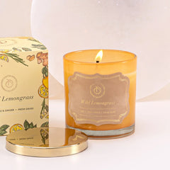Illume Midi - Lid Jar Candle - Saffron - Wild Lemongrass - Set of 2, close-up of lit amber glass with gold label and metal lid