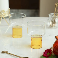 LIFT - Chaat Bowl or Drink Glass in yellow – pair of clear glass bowls on raised yellow bases with a gold spoon