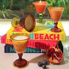 Sundae Votive Candle - Petal · Berry Blonde, sundae glass candles in mixed colours styled on books with pomegranate