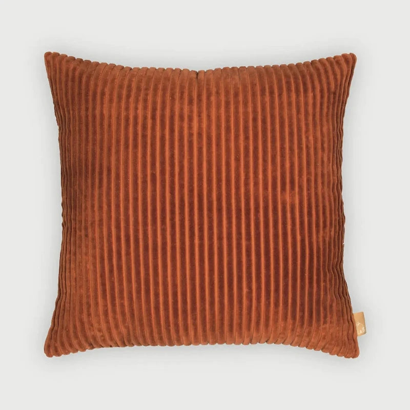 A Luna Burnt Orange Velvet Cushion Cover with a vertical ribbed texture, shown against a light gray background.
