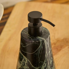 Close-Up of a black matte Spyder Soap dispenser bottle with a dark green and black marble patterned body and Matte Black Pump, shown on a wooden surface.