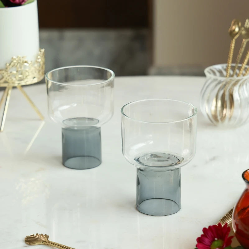 LIFT - Chaat Bowl or Drink Glass in clear black – pair of clear glass bowls on smoky cylindrical bases on marble