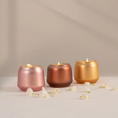 Decorative Scented Carnival Set Of 3, metallic glass Votive Candles | Opulent Oud in different fragrances lit rose, copper and gold votives in a row