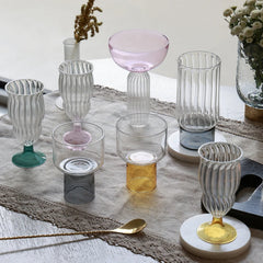 LIFT - Chaat Bowl or Drink Glass – clear black and yellow base glasses styled with fluted glassware on a linen runner