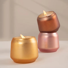 Close view of Scented Carnival Set Of 3,  Votive Candle in rose, copper and gold votives stacked behind
