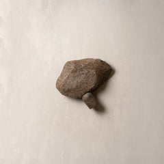 Single stone on a beige background