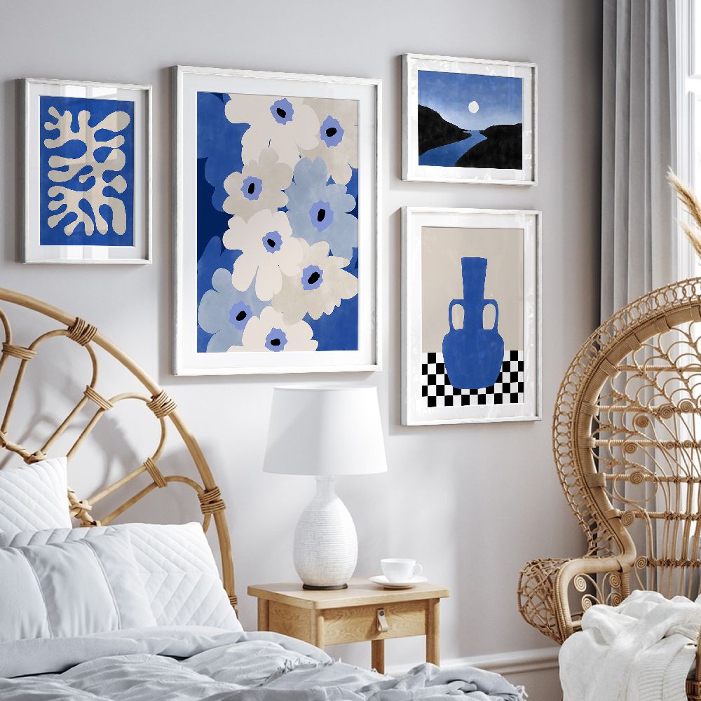 Decorative Indigo Gallery 4-piece art prints in a bedroom with a chair and lamp.