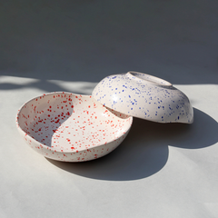 A round Speckled Ceramic bowls with a speckled pattern, featuring a blend of red and blue speckles.