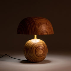 Decorative small wooden table lamp with a textured dark brown shade on a dark background