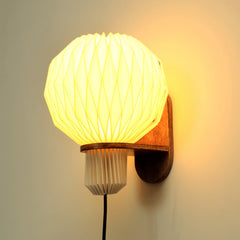 Origami-inspired linen wall sconce (Aura Pleat) with soft ambient glow