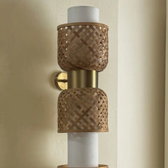 Wall-mounted wall light fixture with woven brown bamboo texture, brass finish and LED lighting.
