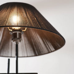 Close-up of a lamp with a black shade on a white background