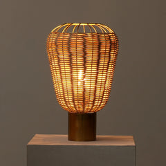 Woven Meiji Table Lamp with a warm glow on a dark background