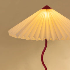Wavy Floor Lamp showing pleated shade and red base with warm lighting