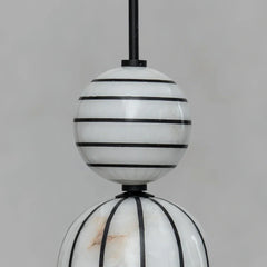 Decorative hanging lamp with striped design on a gray background