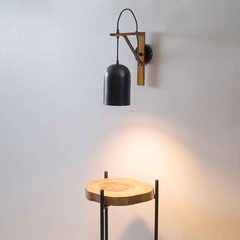 Industrial style wall sconce illuminating modern living room corner