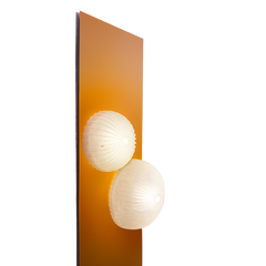 Unique floor lamp illuminated, casting a warm ambient glow
