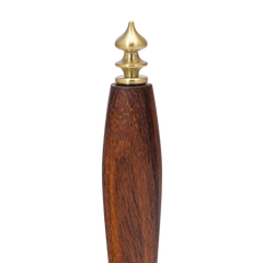 Wooden bell with a brass top on a white background