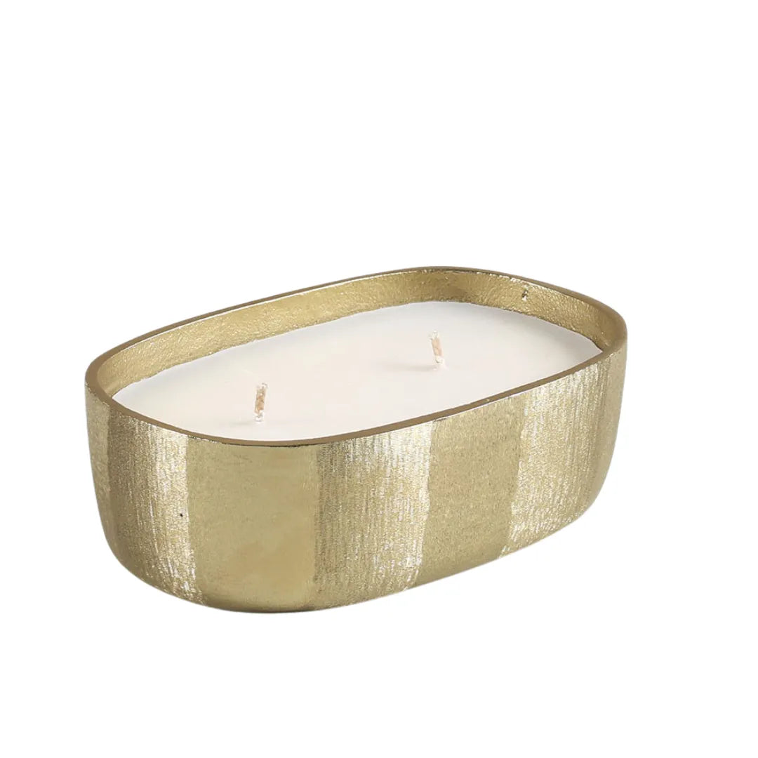 Fleur Votive Gold candle holder with a white candle on a white background