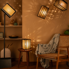 Modern Reeding Floor Lamp with warm lighting surrounded with more handwoven cane lights
