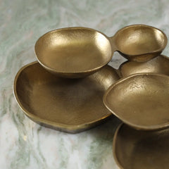 Set of gold Comet Bowls on a marble surface