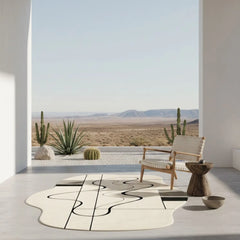 Modern interior with a desert view through a large window, featuring a chair and decorative items.