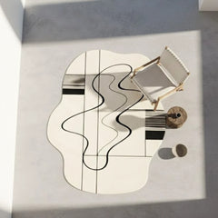 Abstract art piece on a white surface with geometric shapes and wavy lines.