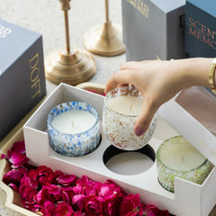 Monet's Garden Votive Candle with Stunning Oud scent, Set Of 3, hand placing a votive in open gift box beside rose petals