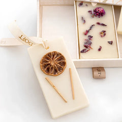 The Signature Trio · Wax Tablet · Flower Blossom, Lemongrass and Lavender, dried orange tablet on cream Doft ribbon, close-up