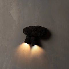 Modern wall-mounted light fixture on a textured wall