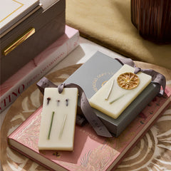 Flower Blossom & Lemongrass · Wax Tablet · Set of 4, two DOFT tablets on grey gift box styled on books