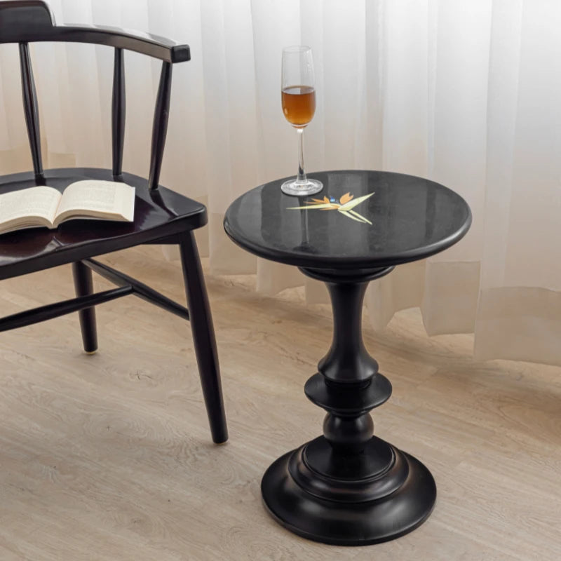 Bird of Paradise - Black accent table with inlaid black marble top in living room beside chair
