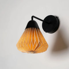 Linen Downlighter  Wall Sconce with black fixture and brown glowing geometric shade on a light gray background