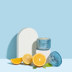 Orange Cassis Fragrance Trinket Jar Candle, aqua glass jar on white arch plinth with orange and lemon slices