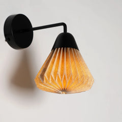 Wall-mounted Linen Downlighter Wall Sconce with black fixture and fabric shade casting warm light on a light gray background