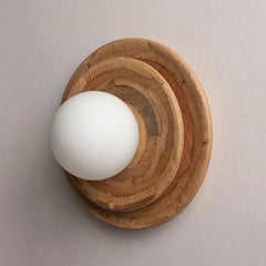 Tiered wall-mounted wooden light with a white bulb on a neutral background