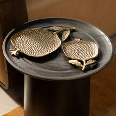 Decorative Roma trays in 2 different sizes are placed on a round side table with a brown background