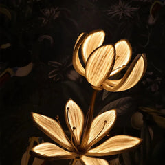 Decorative gold flower floor lamp illuminated, showing its warm ambient glow
