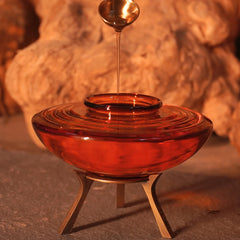 Muun Ghee Daani, ghee dripping from spoon into ridged amber borosilicate glass pot on metal stand