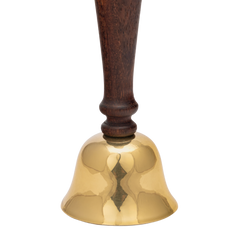 Gold brass bell with a wooden handle on a white background