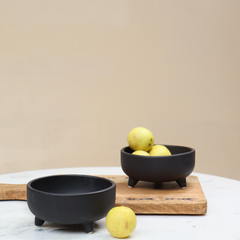 2 Black color Ceramic Pluto Bowls placed on a marble table