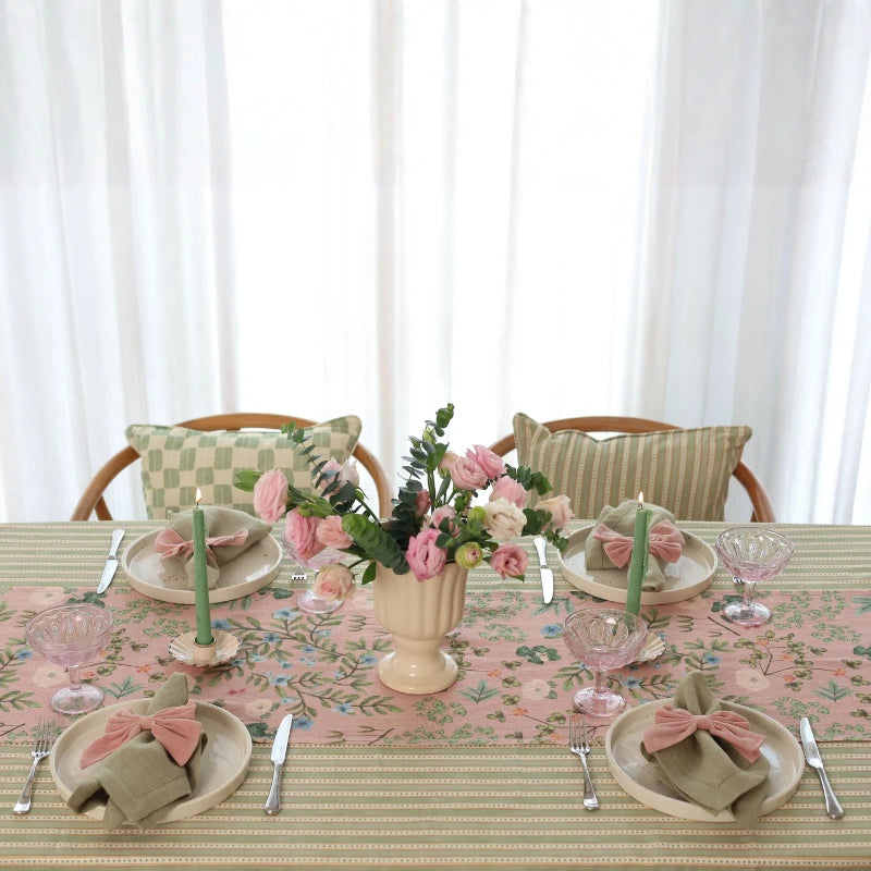 Valley Rose Linen Table Runner on striped tablecloth with rose centrepiece, front view